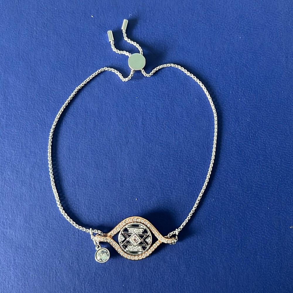 Swarovski adjustable bracelet. Silver/rose gold w/dangling crystal. Never worn.